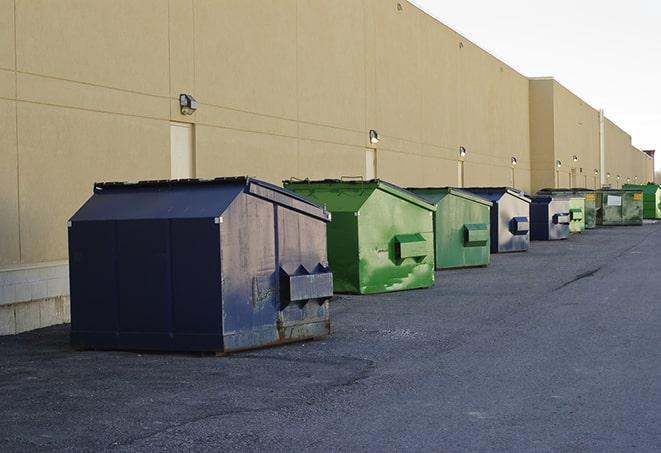 a series of colorful, utilitarian dumpsters deployed in a construction site in Cambridge